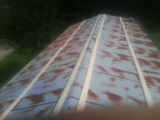 Rusted metal roof panels with new wood purlins before replacement — Storm Damage Roof Repair in Delaware City by Roofing Brothers