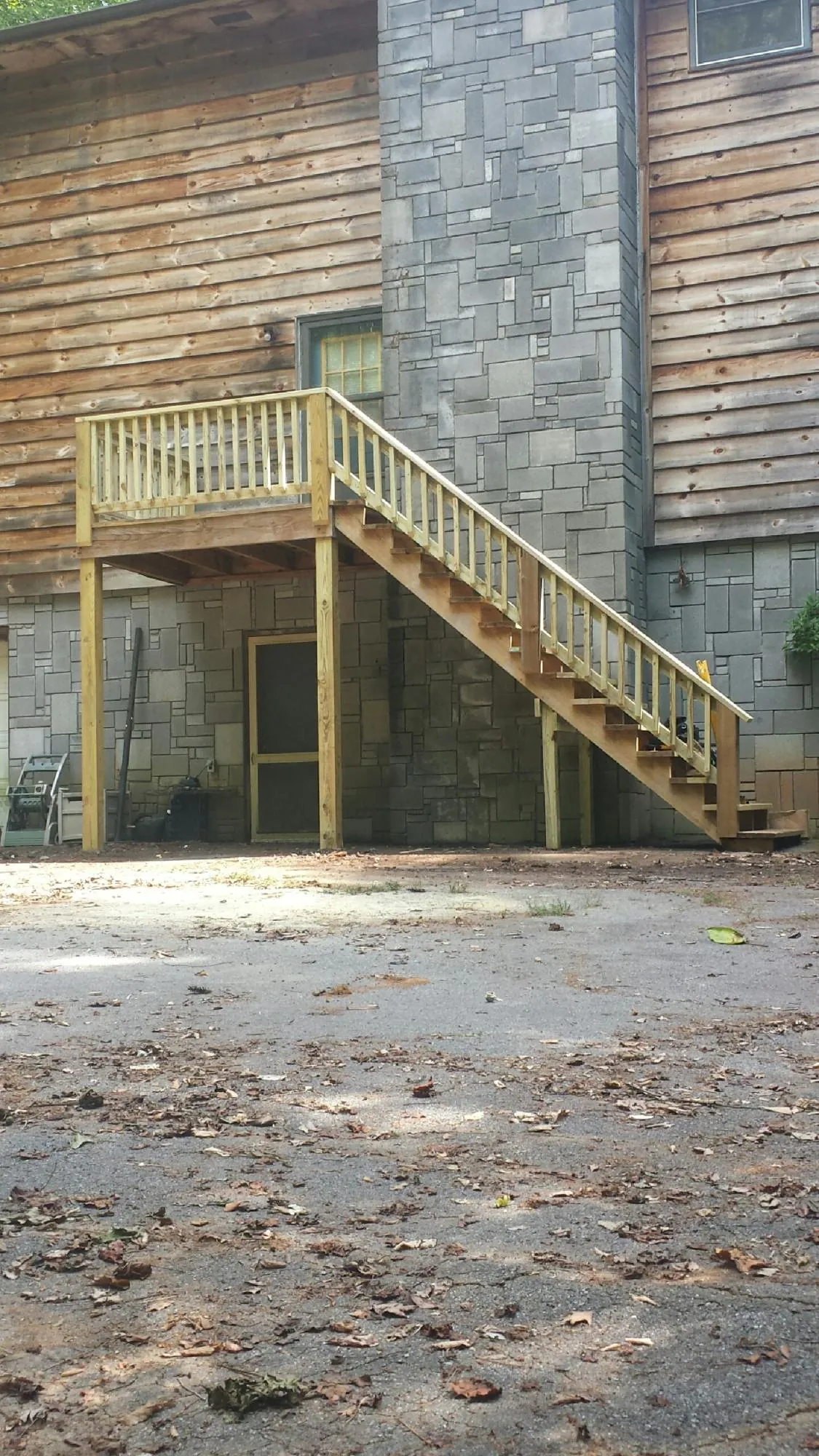 New pressure treated deck and stair landing on a log home in Delaware City